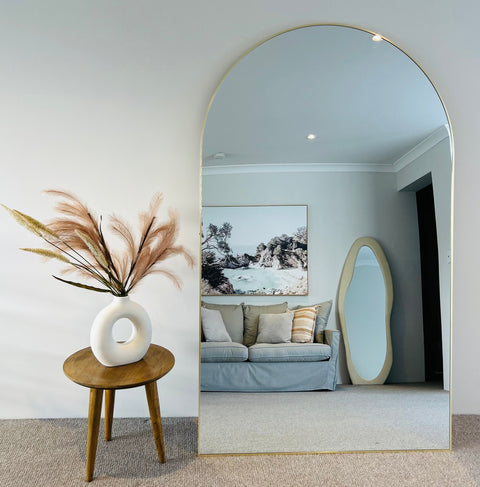 Monique oversized arched leaner mirror in a living room
